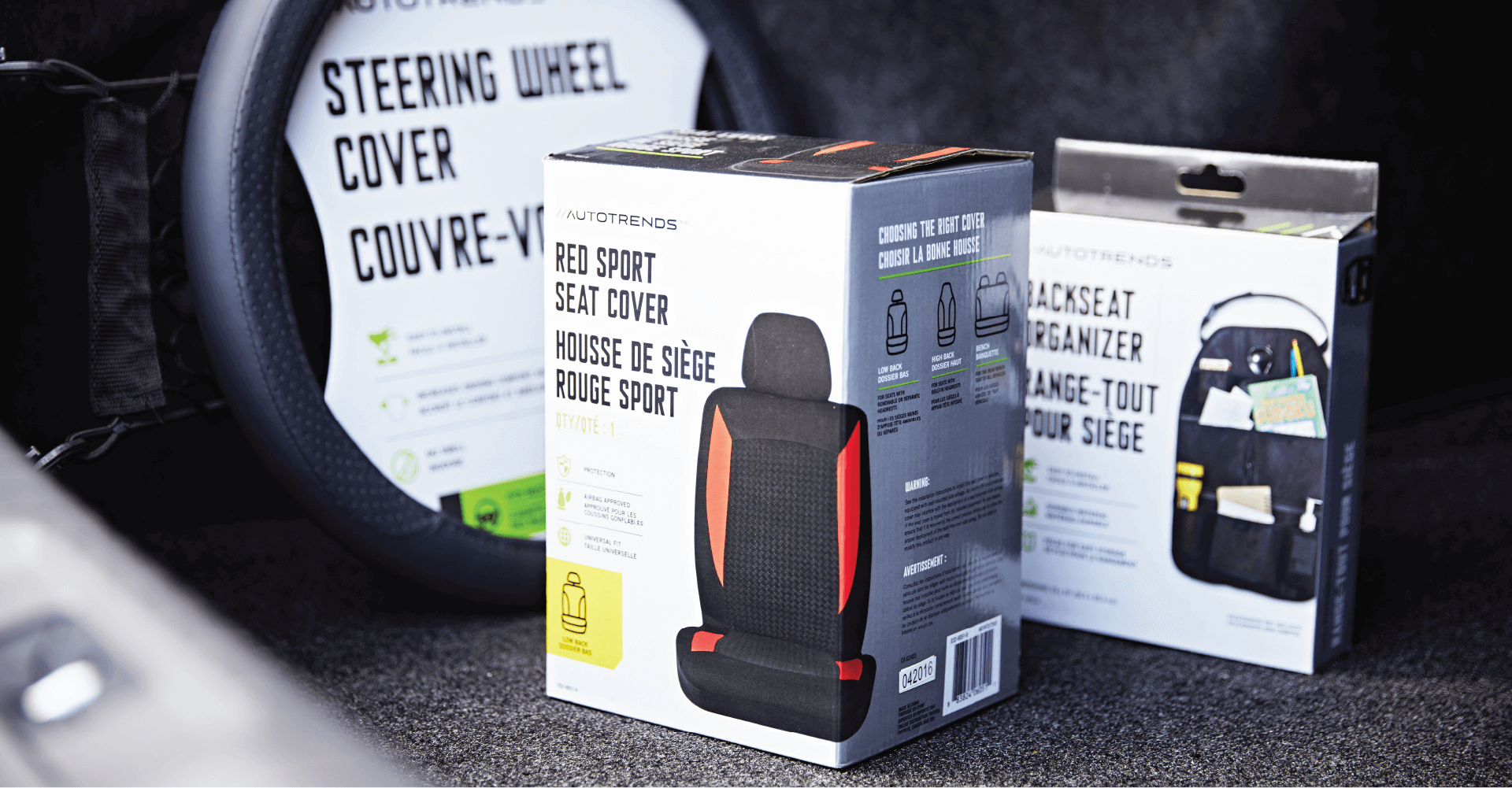 A steering wheel cover and a seat cover are sitting in the back of a car.