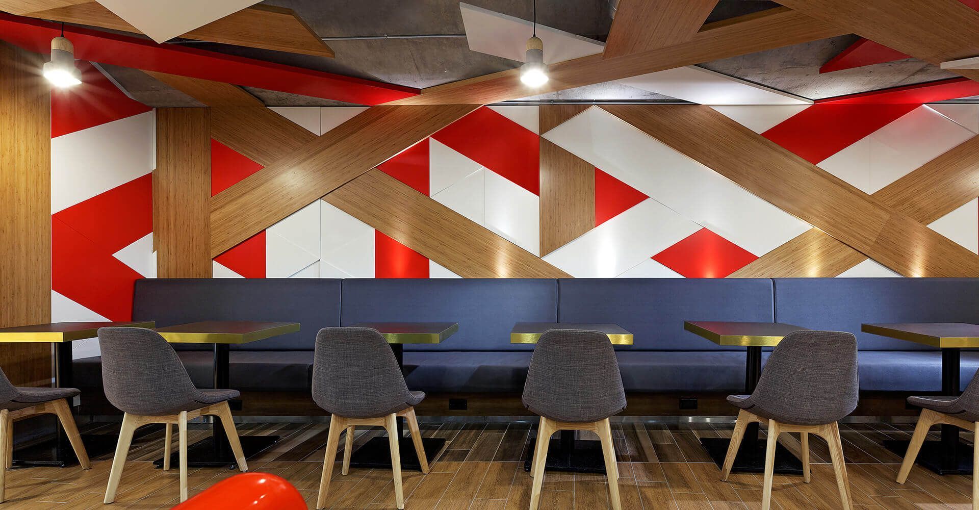 A room with tables and chairs and a red white and blue wall.