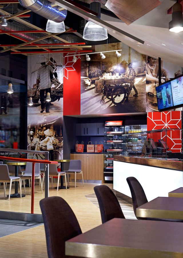 A restaurant with tables and chairs and pictures on the wall