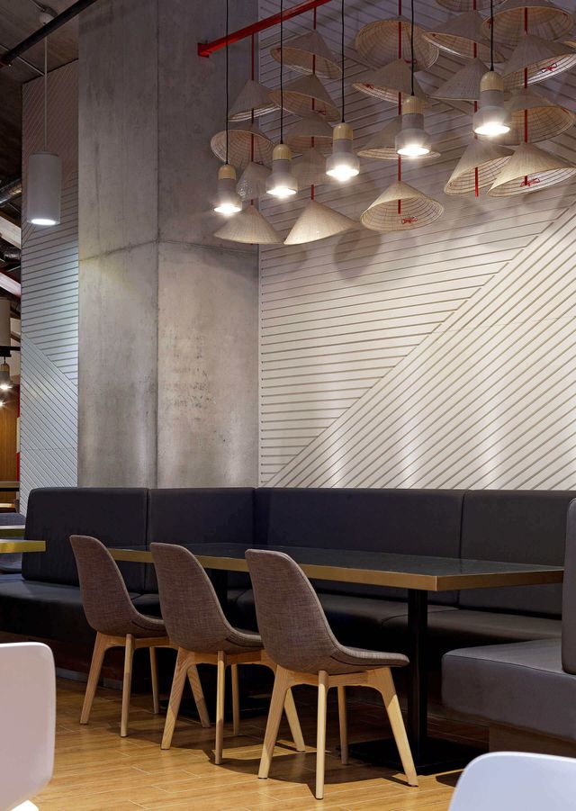 A restaurant with tables and chairs and a striped wall