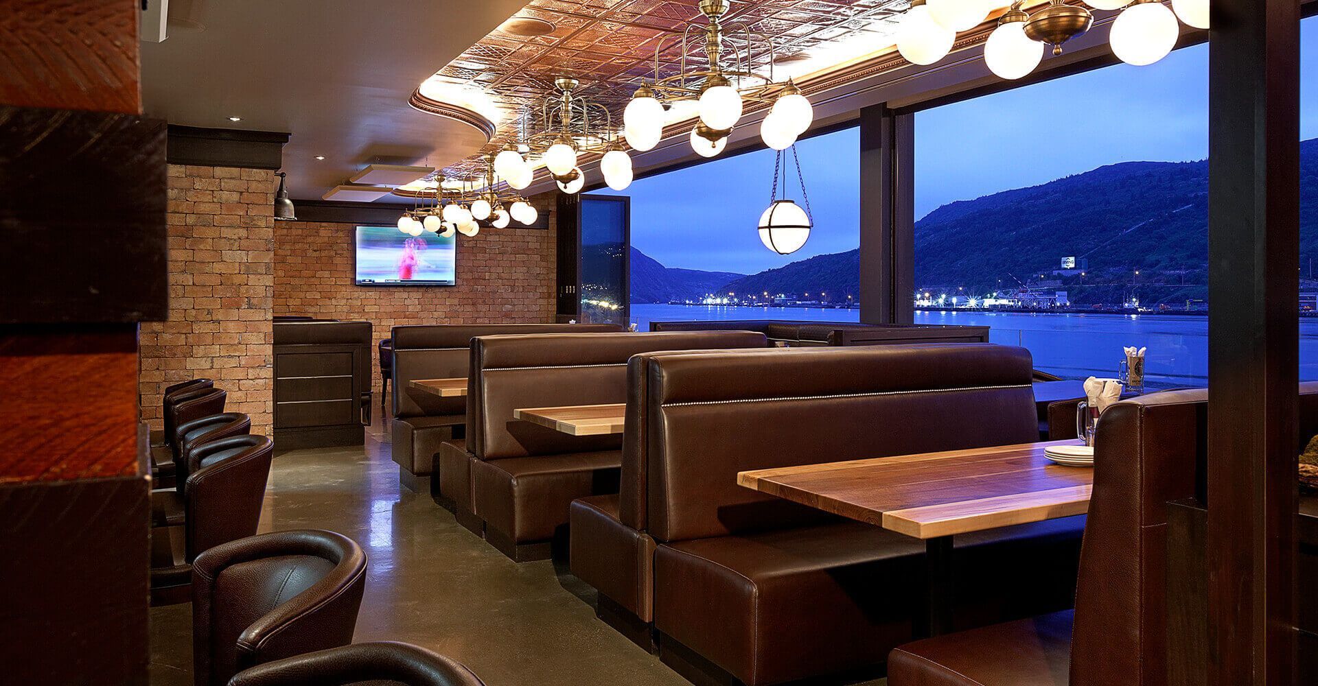 A restaurant with a view of the water and mountains