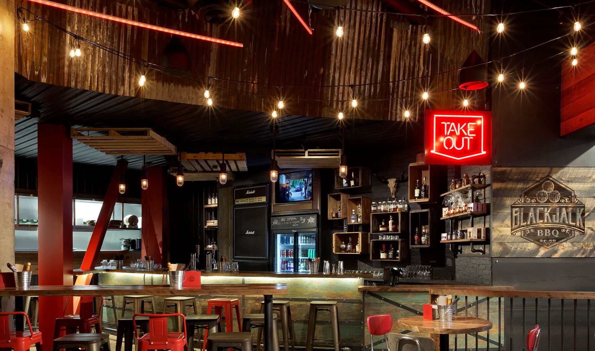 A restaurant with a neon sign that says love out