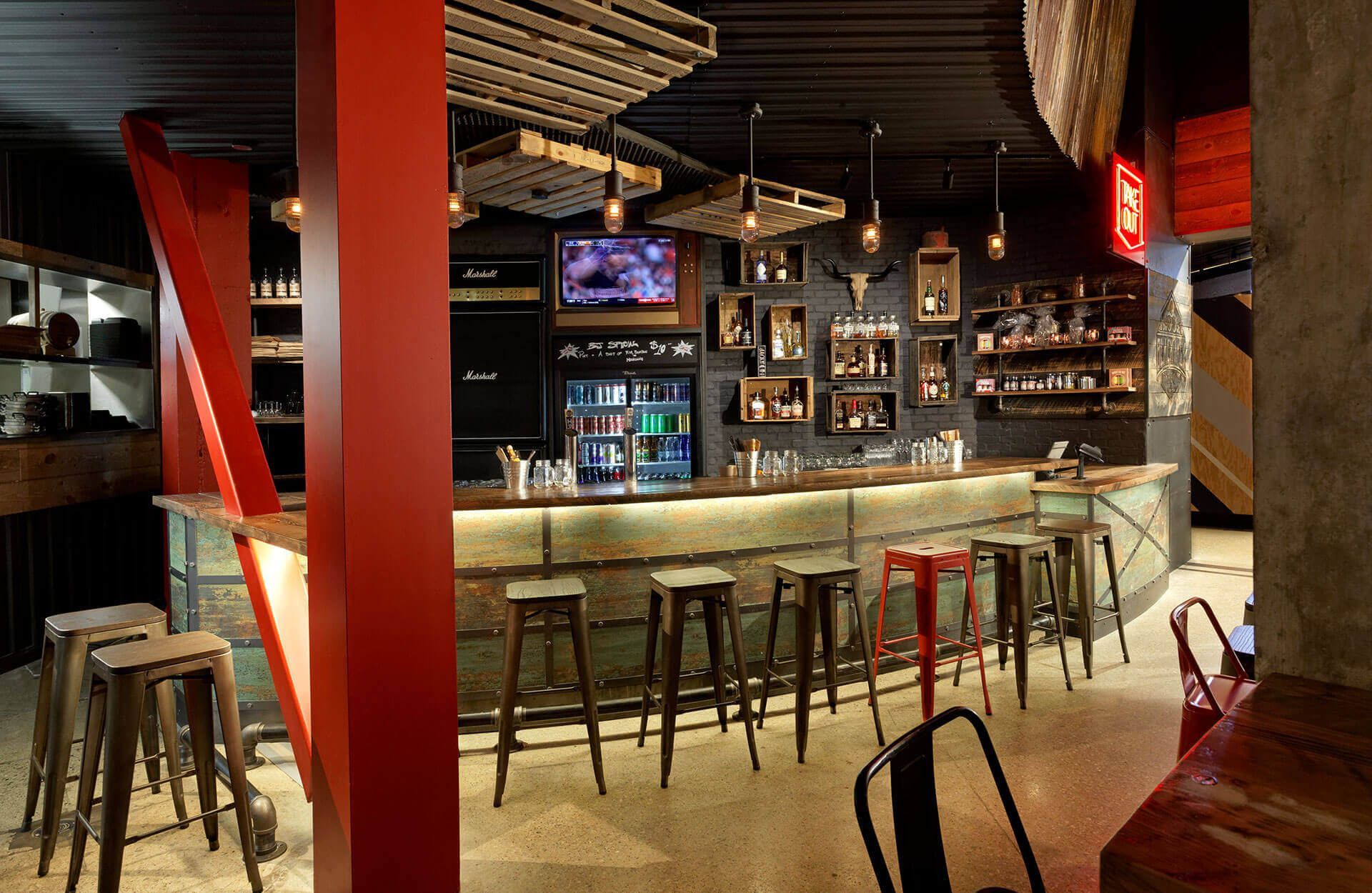 A restaurant with a long bar and stools