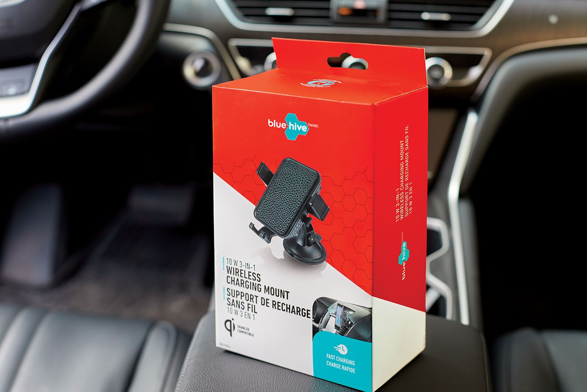 A red and white box is sitting on a car console.