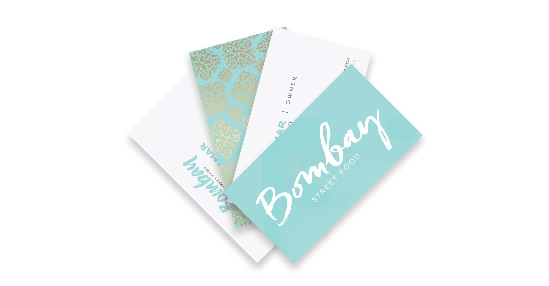 Three business cards are stacked on top of each other on a white surface.