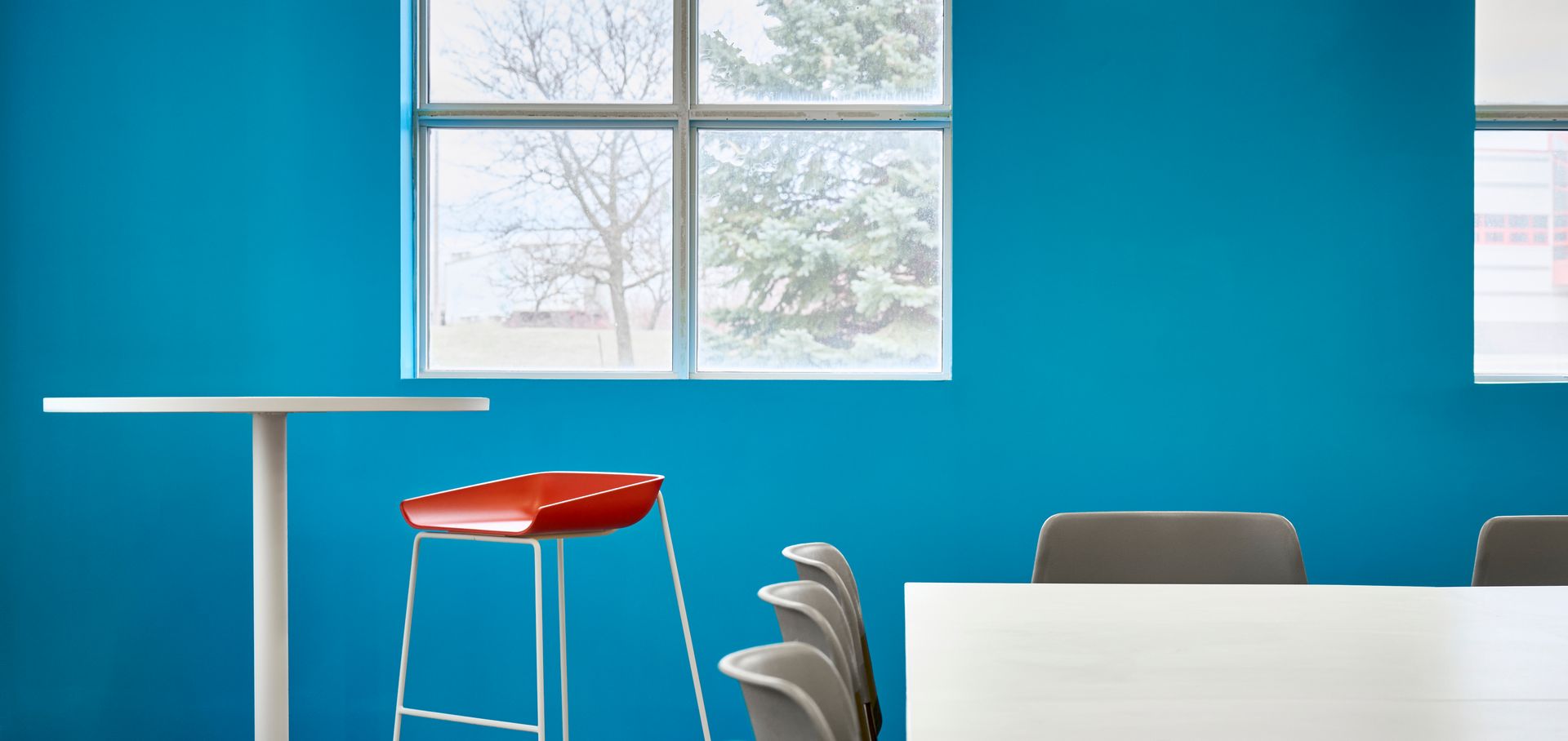 There is a table and chairs in the room with blue walls.