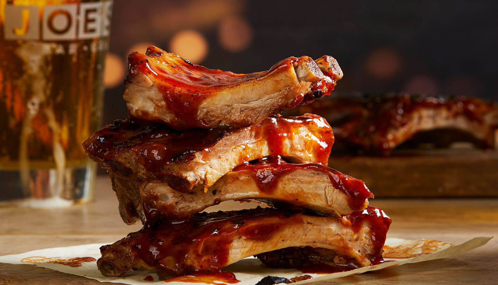 The ribs are stacked on top of each other on a plate.