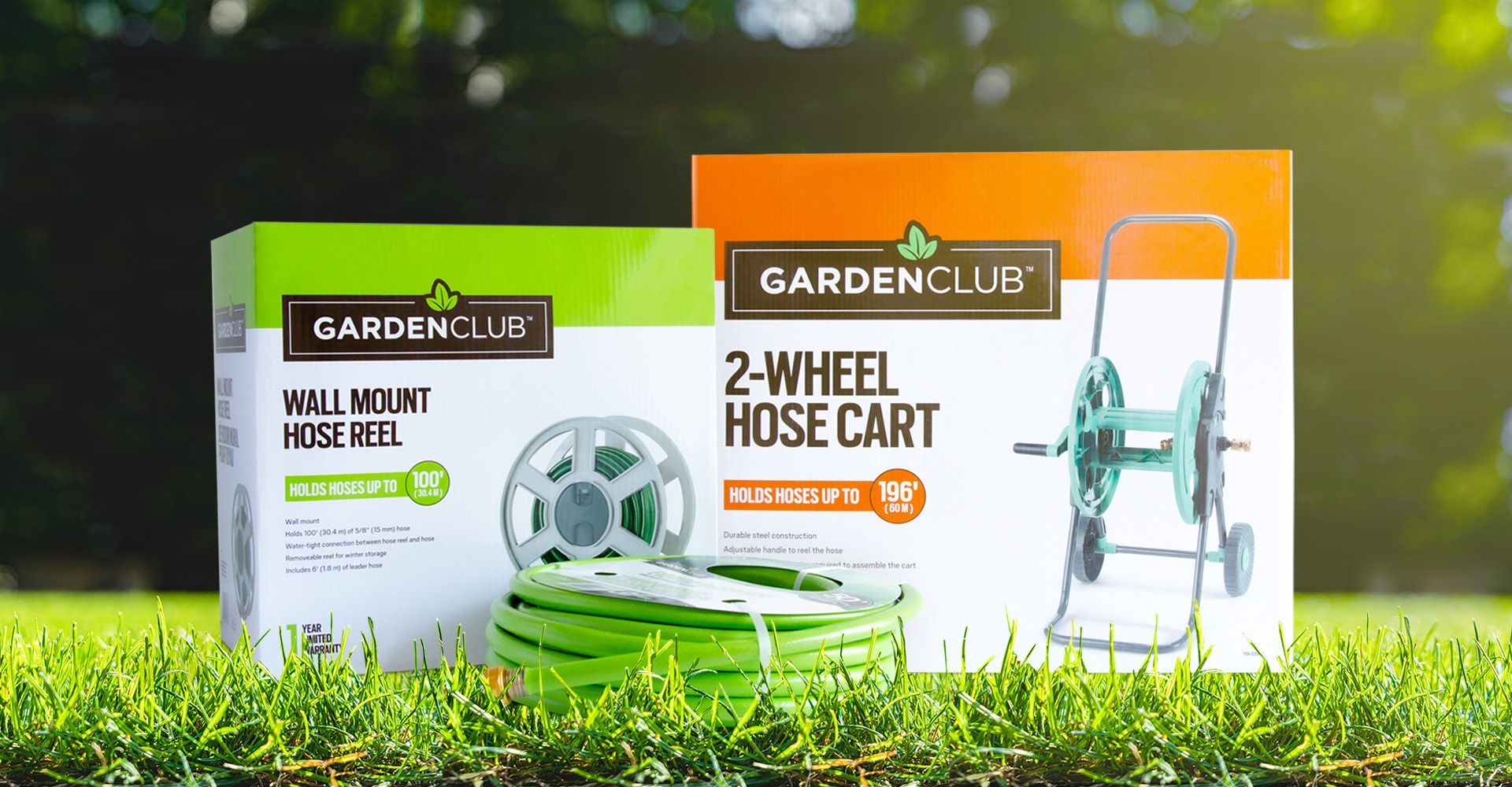 A garden club 2 wheel hose cart is sitting on top of a lush green field.