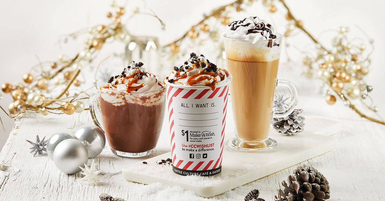Two cups of hot chocolate and a cup of coffee are sitting on a table.