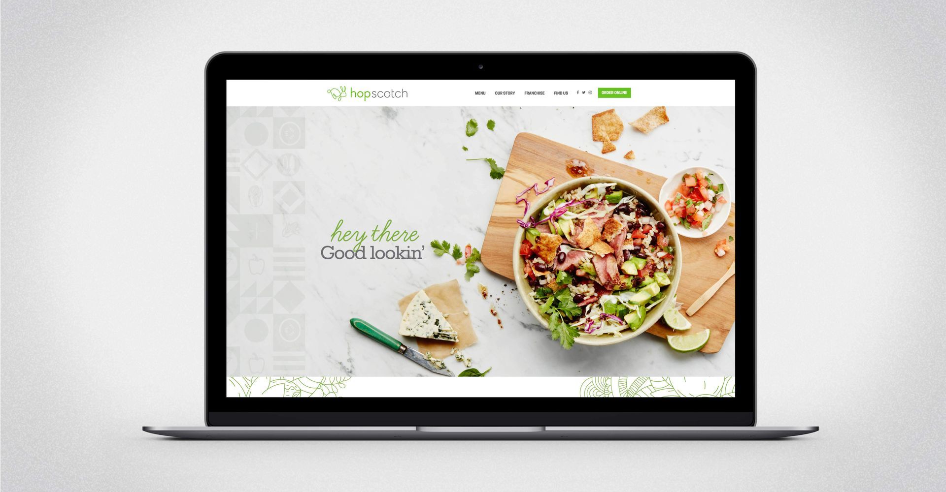 A laptop with a picture of a salad on the screen.