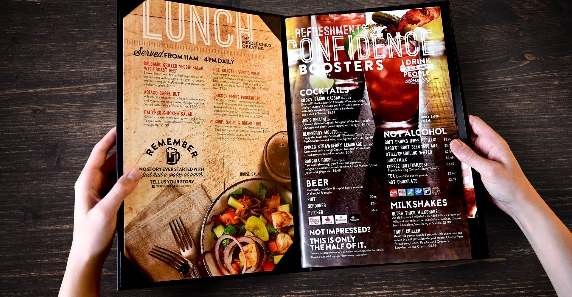 A person is holding a menu open to a page that says lunch