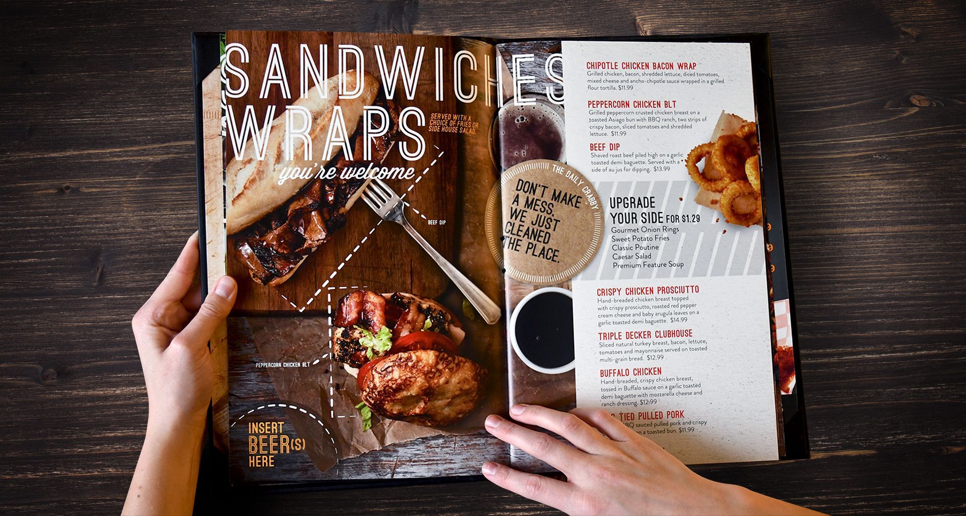 A person is holding a menu with sandwiches and wraps on it.