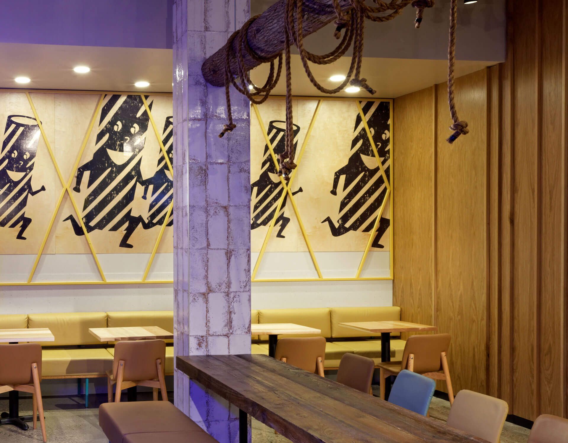A restaurant with tables and chairs and a rope hanging from the ceiling