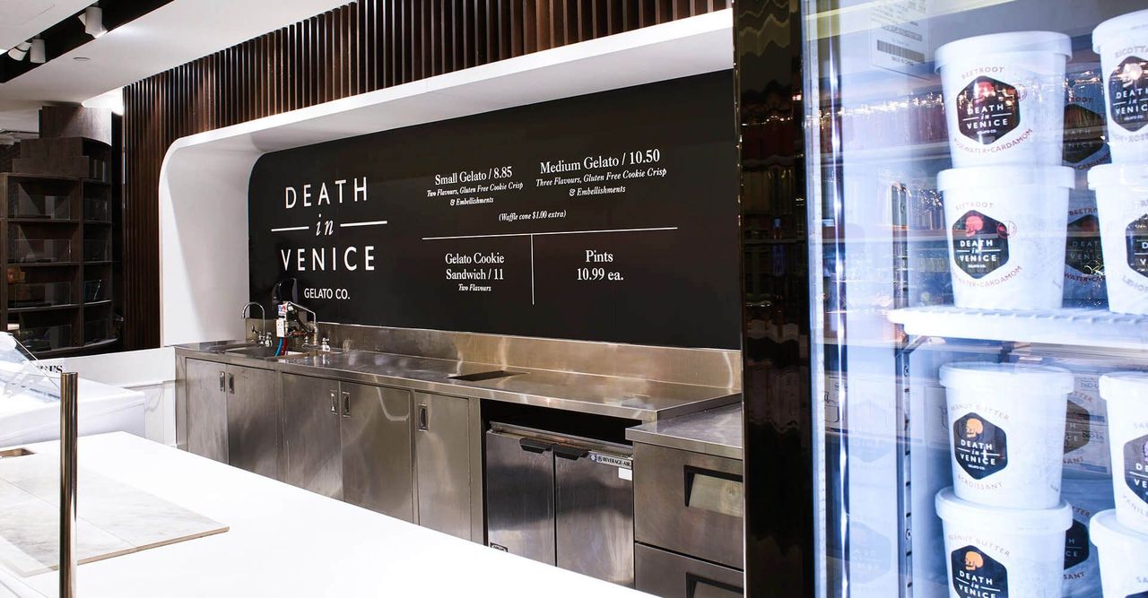 a barista cleaning dishest behind the death in venice counter.