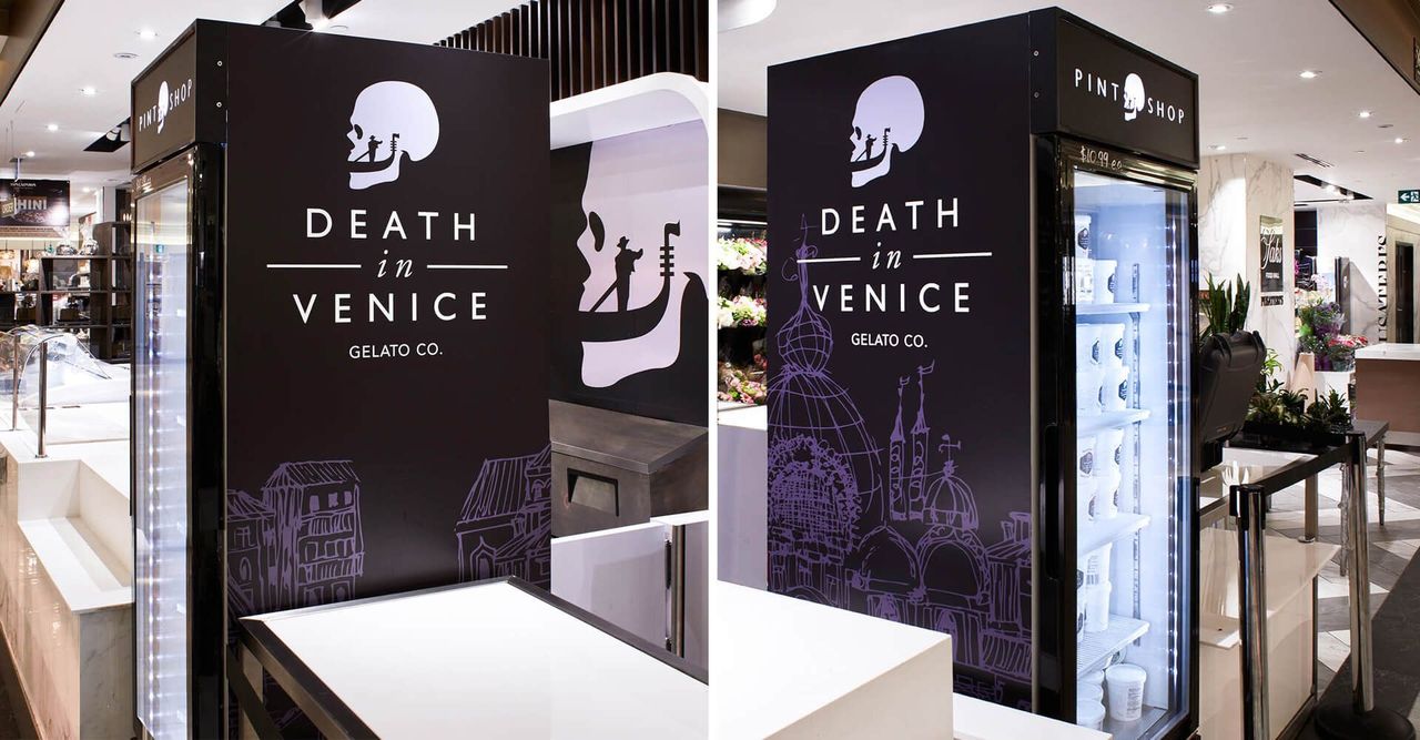 A fridge with a skull on it is in a store.