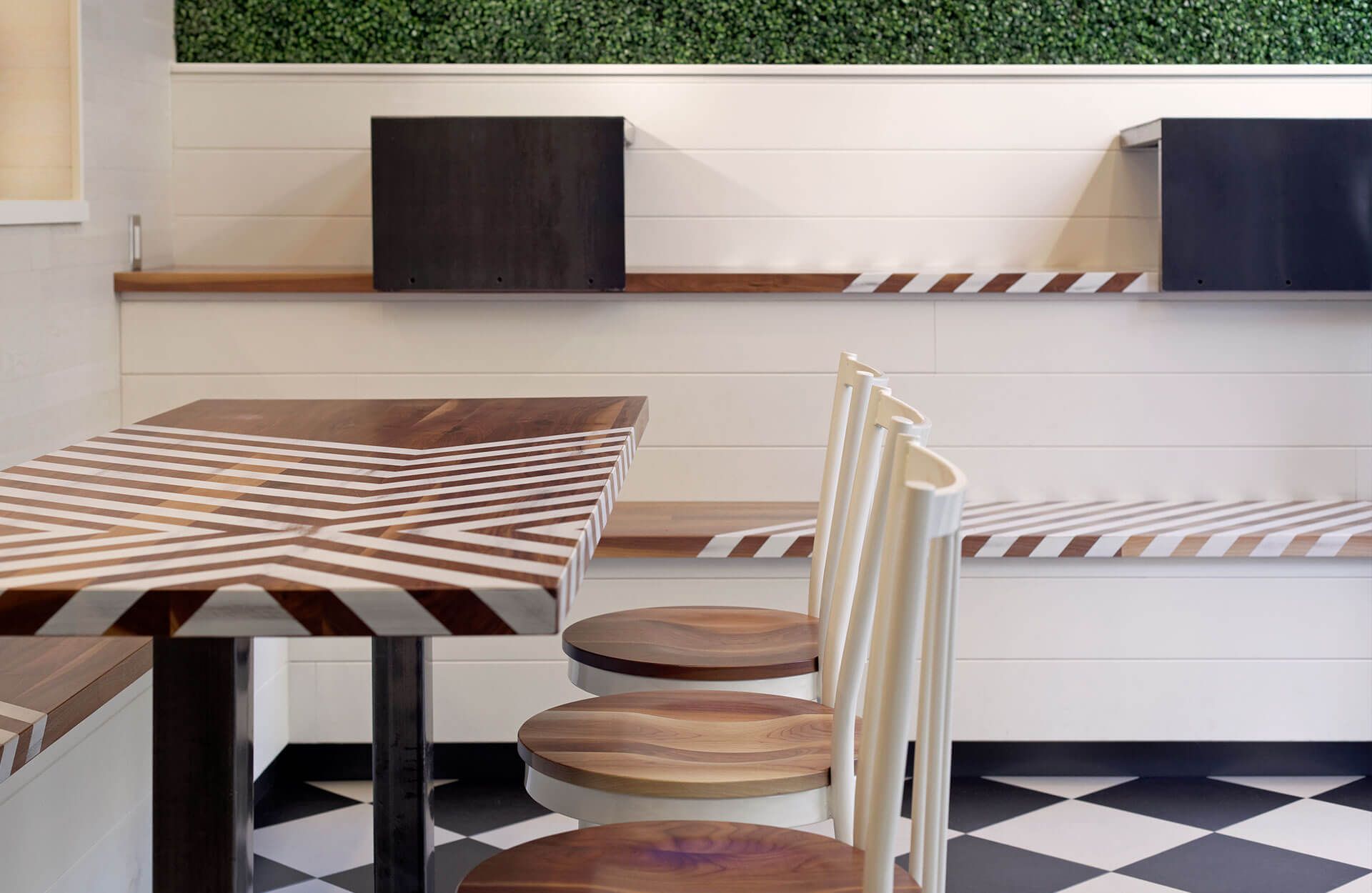 A table and chairs in a room with a checkered floor
