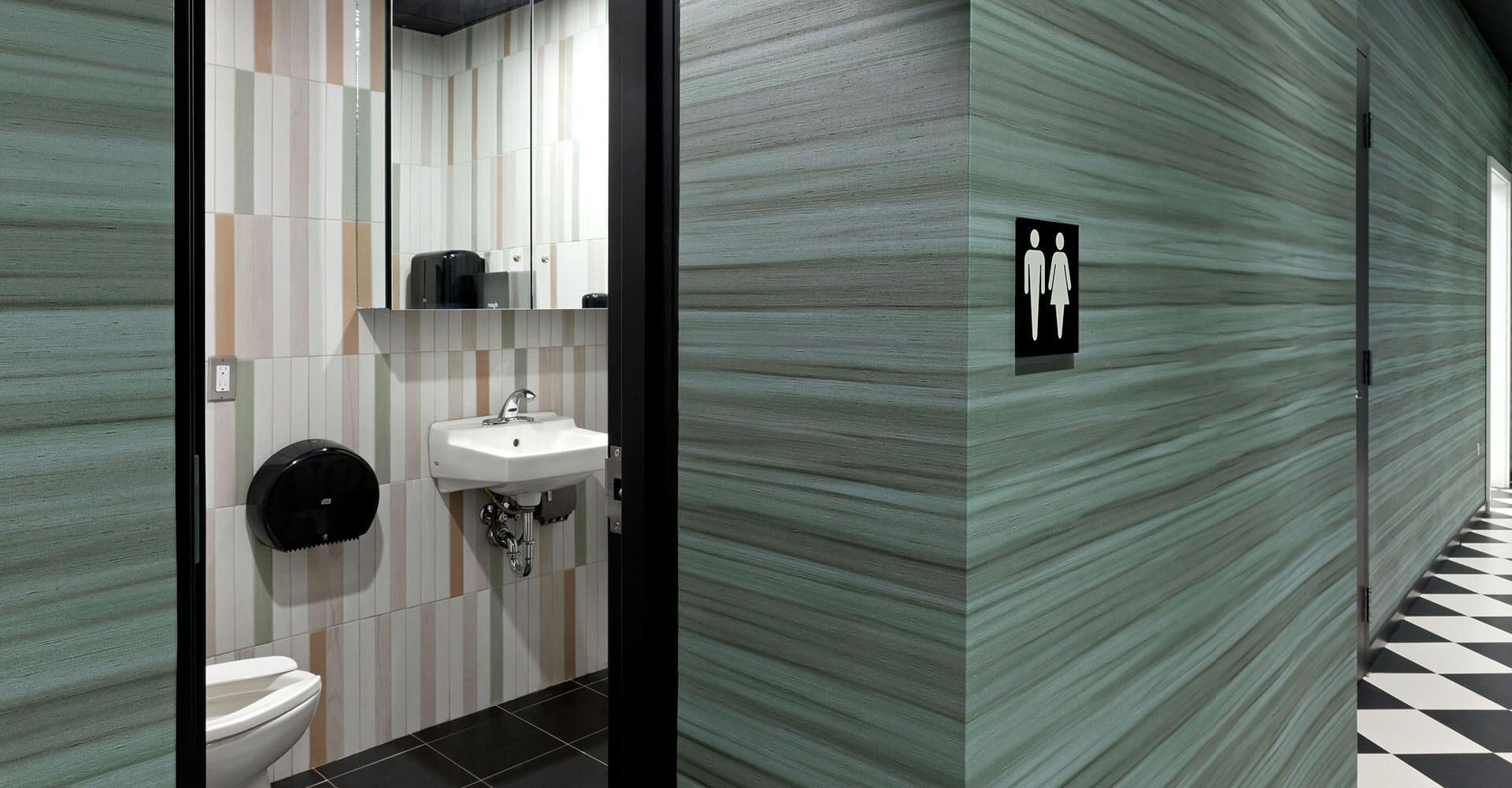 A bathroom with a sink and toilet in a hallway.