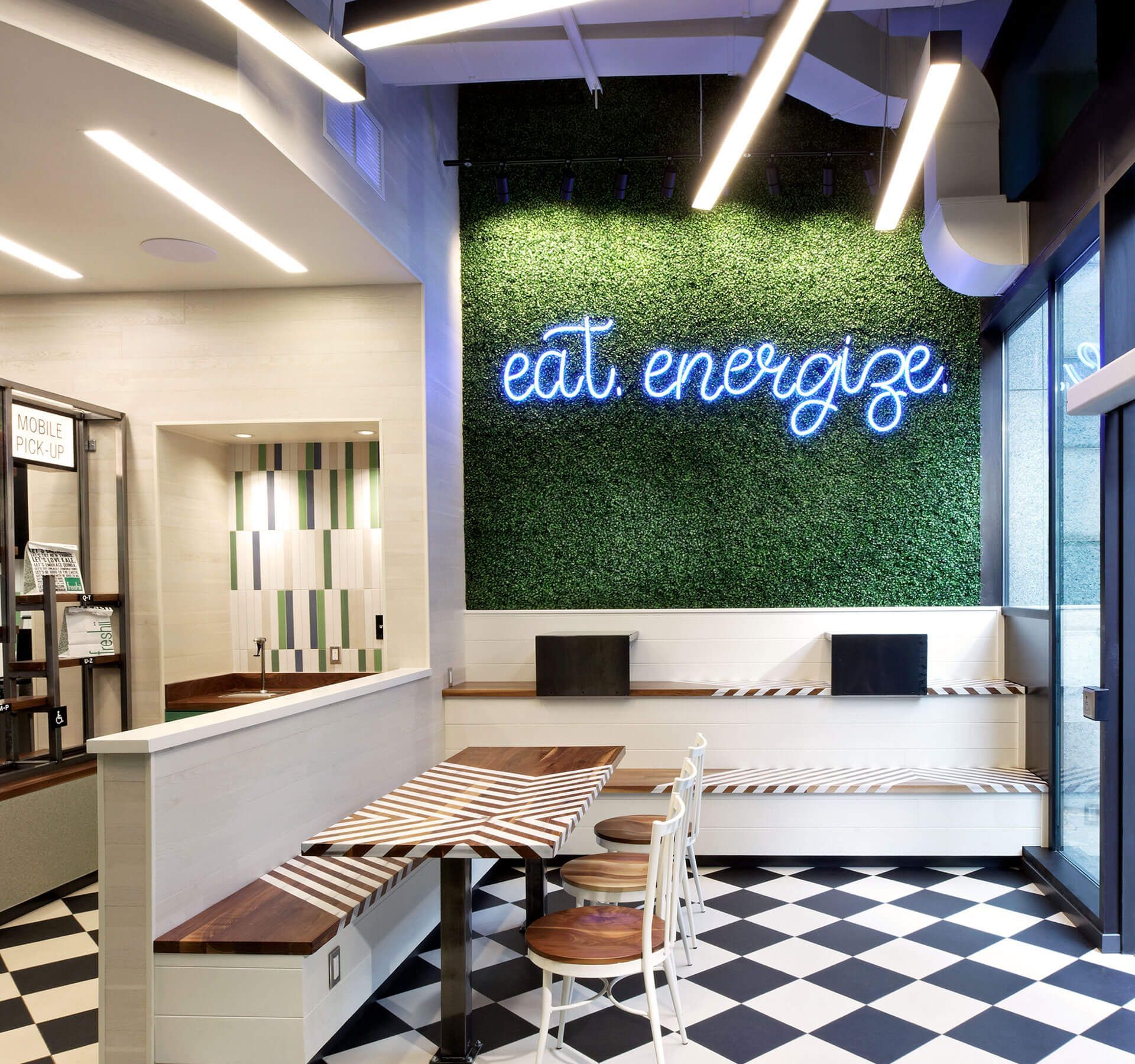 A restaurant with a neon sign that says eat energize