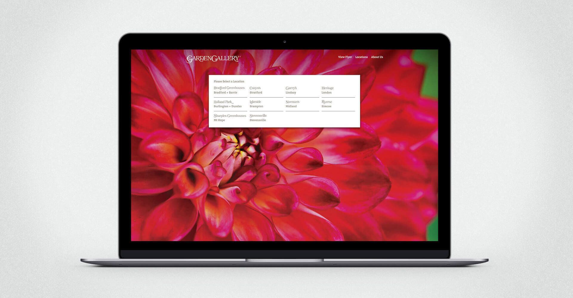 A laptop with a red flower on the screen.