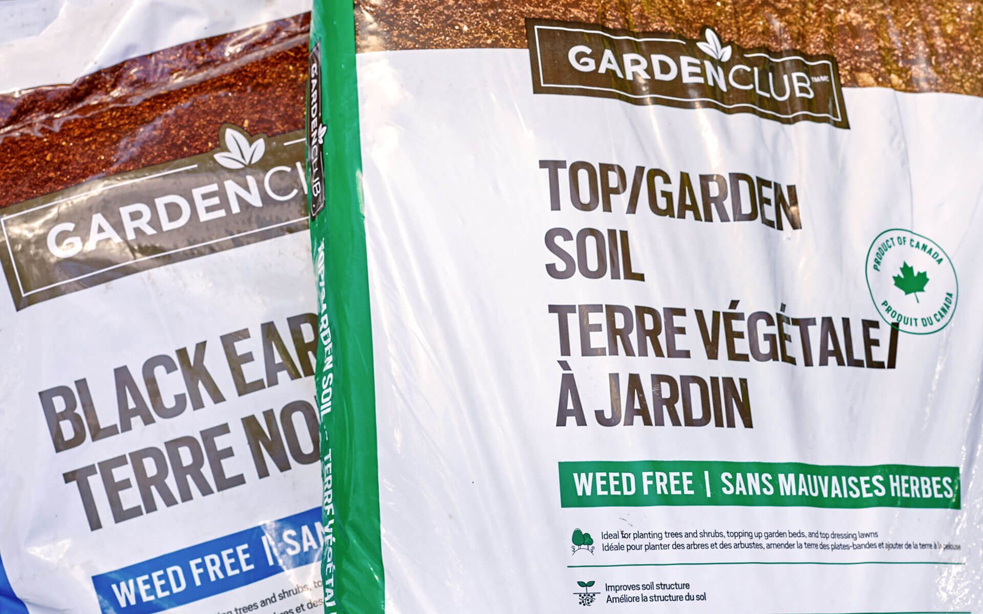 Two bags of garden soil are sitting next to each other.