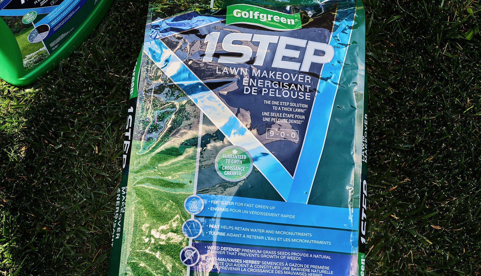 A bag of 1 step lawn fertilizer is sitting on the grass