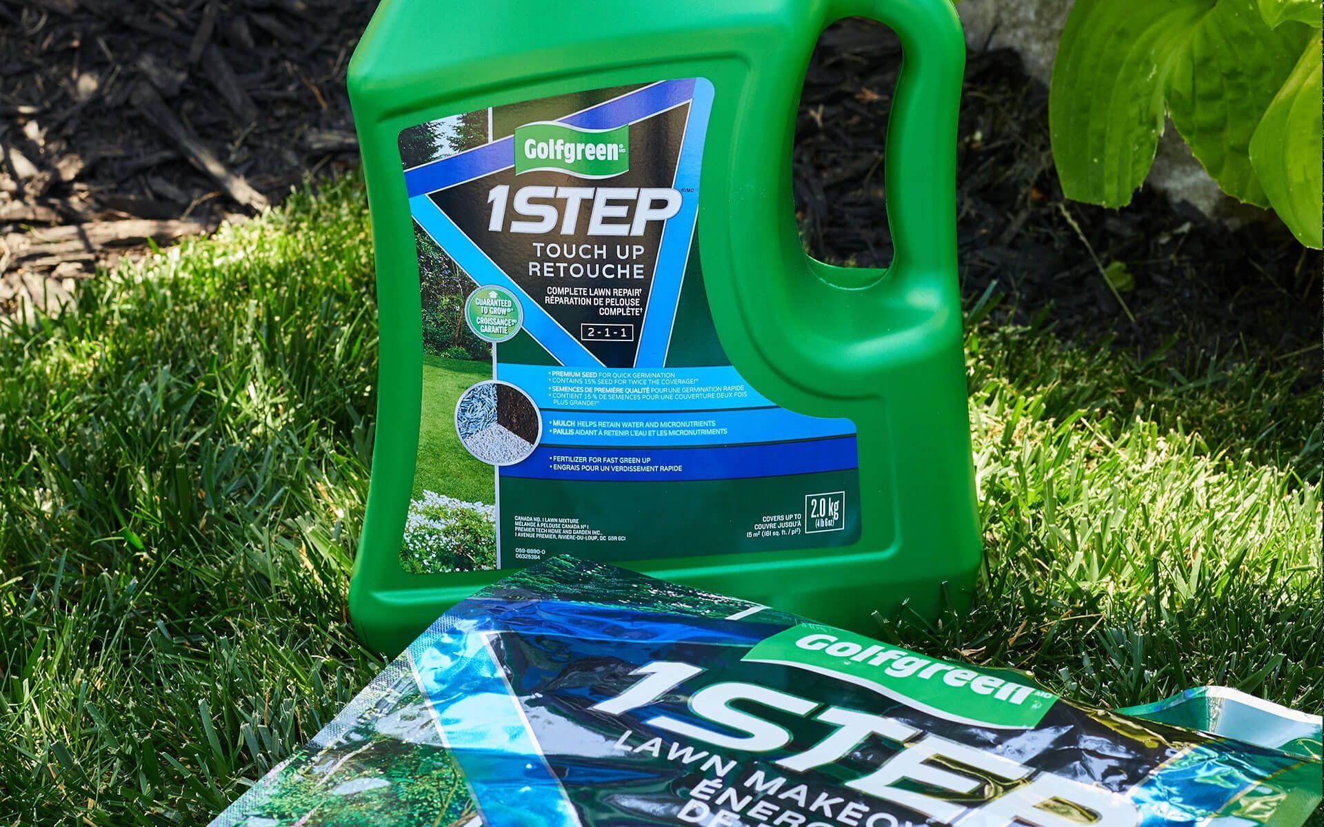 A bottle of 1 step lawn fertilizer is sitting on top of a bag of fertilizer.