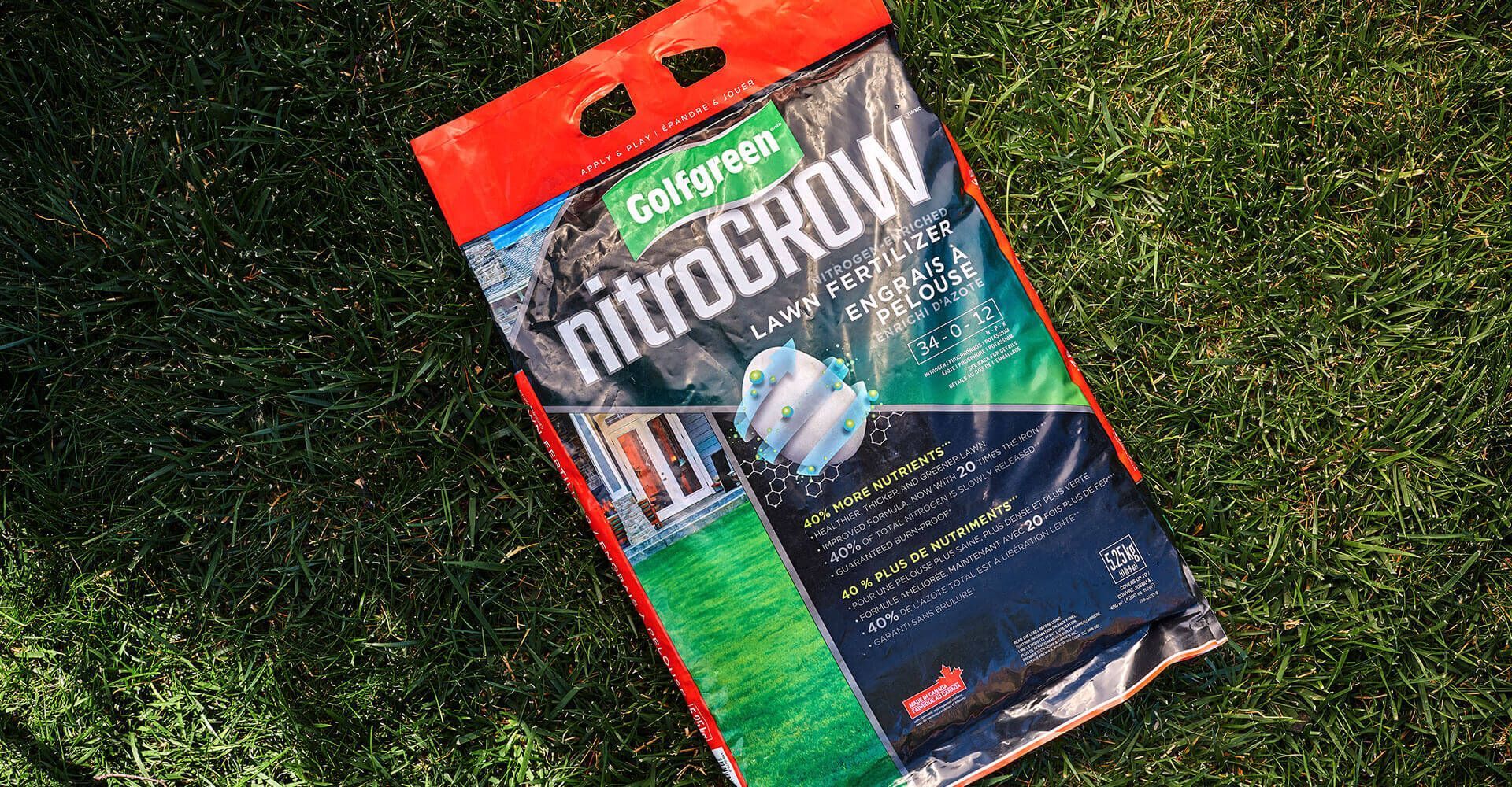 A bag of nitrogrow is sitting on top of a lush green field.