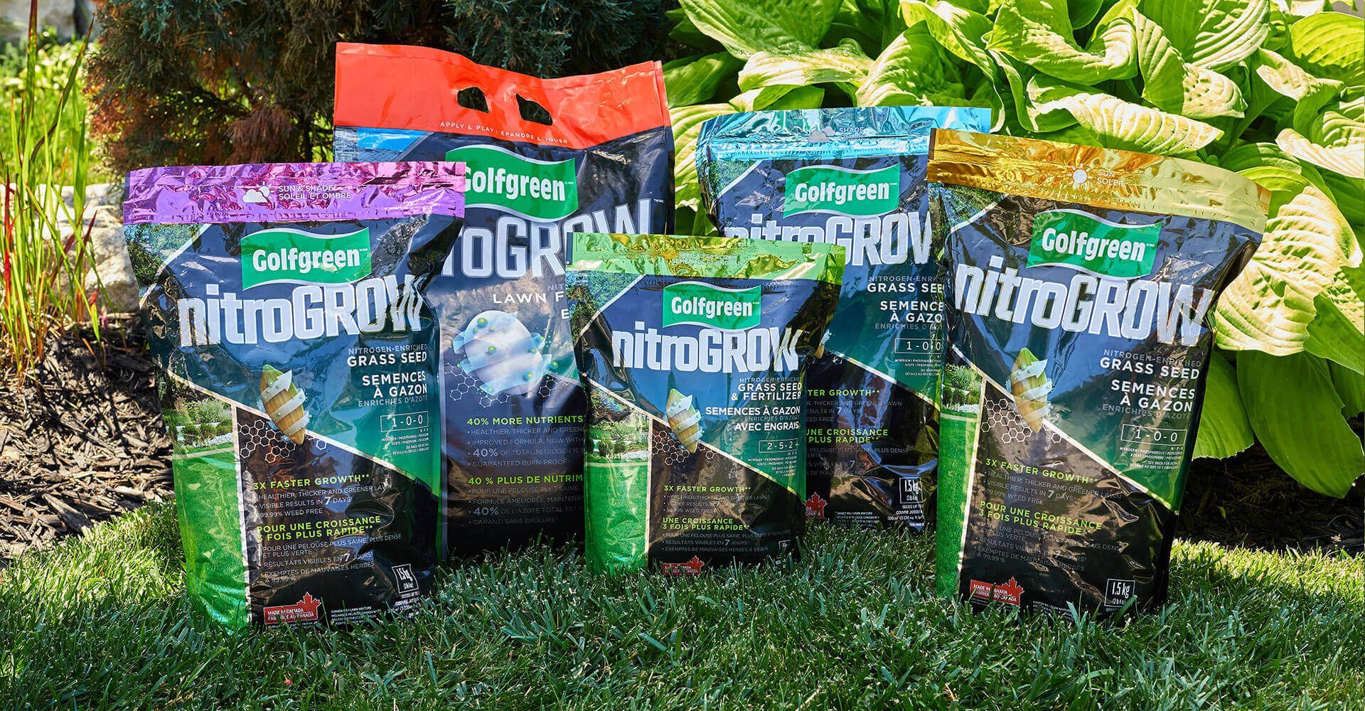 A group of bags of fertilizer are sitting on top of a lush green field.