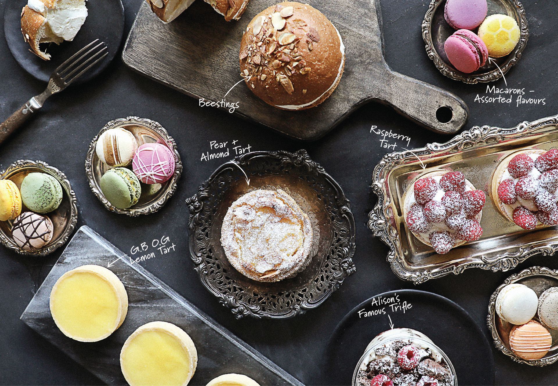A table topped with a variety of desserts and pastries