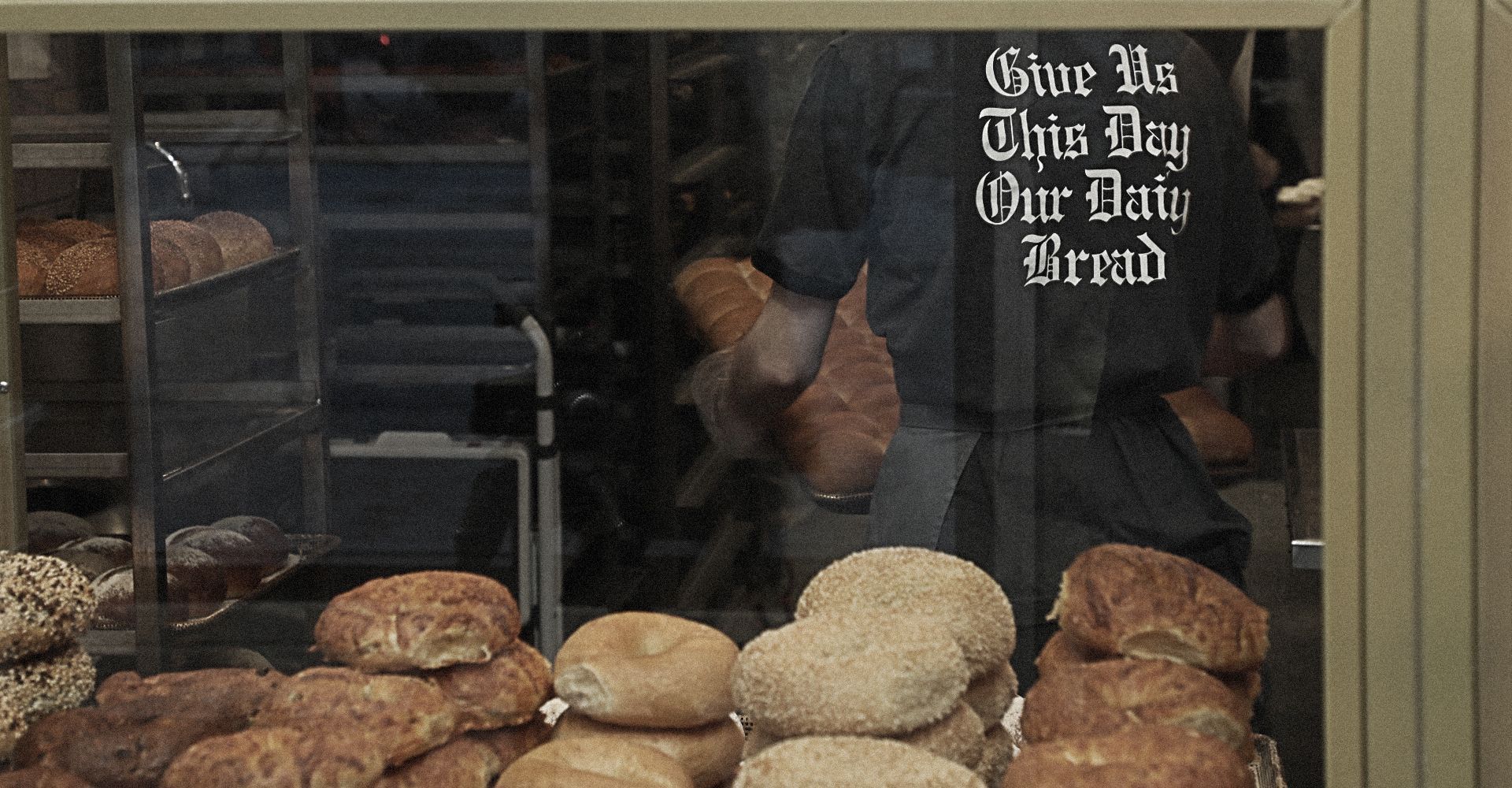 A bakery with a sign that says give us this day our daily bread