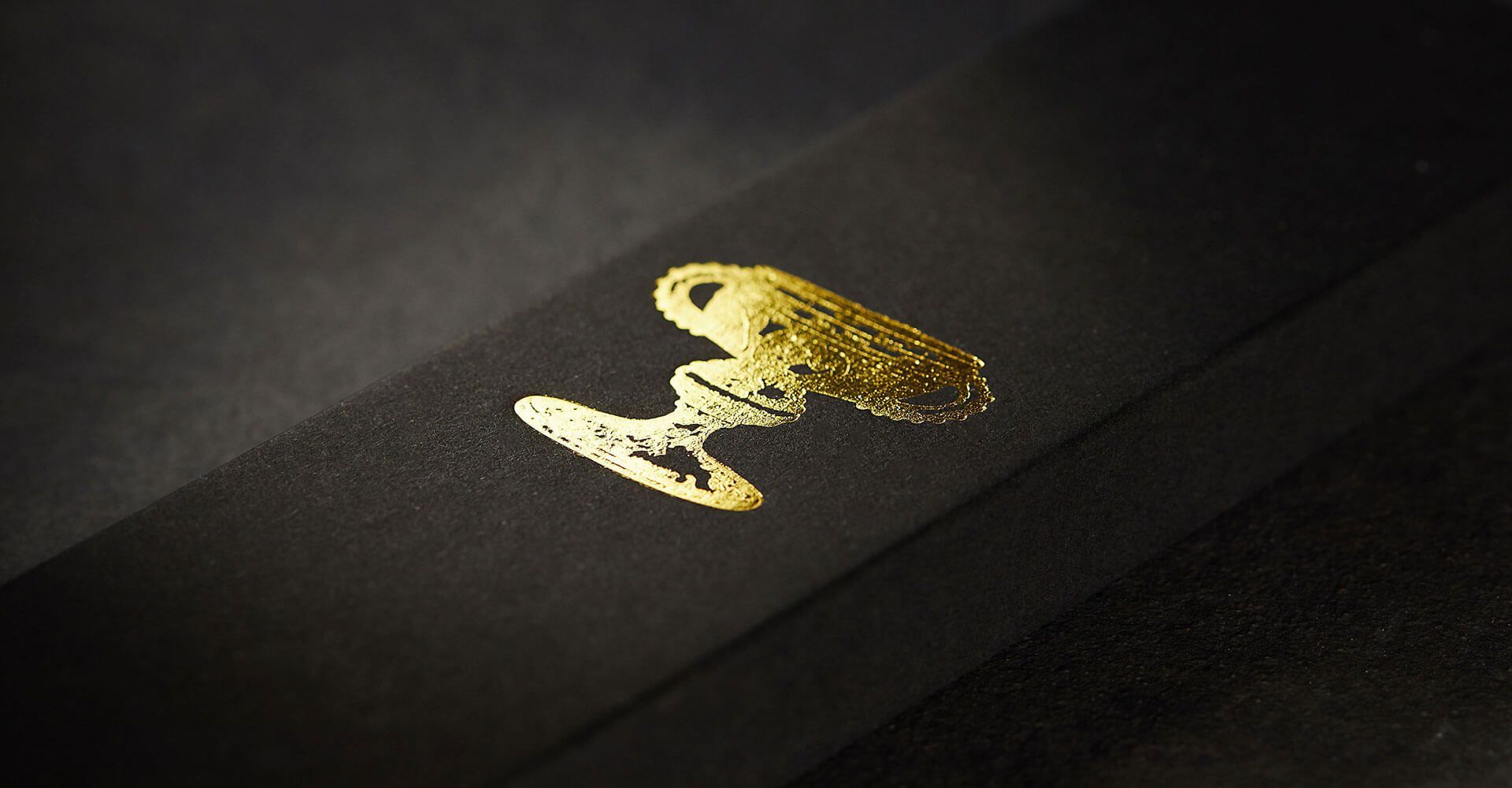 A close up of a black box with gold foil on it.