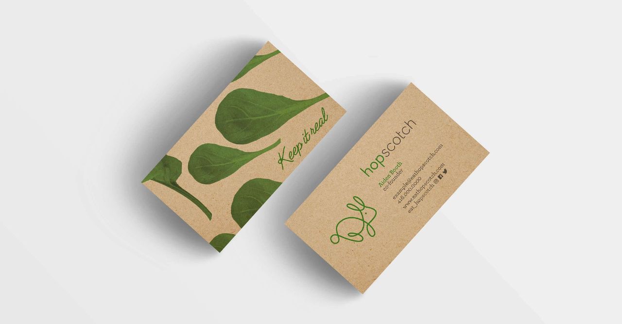 Two business cards with green leaves on them