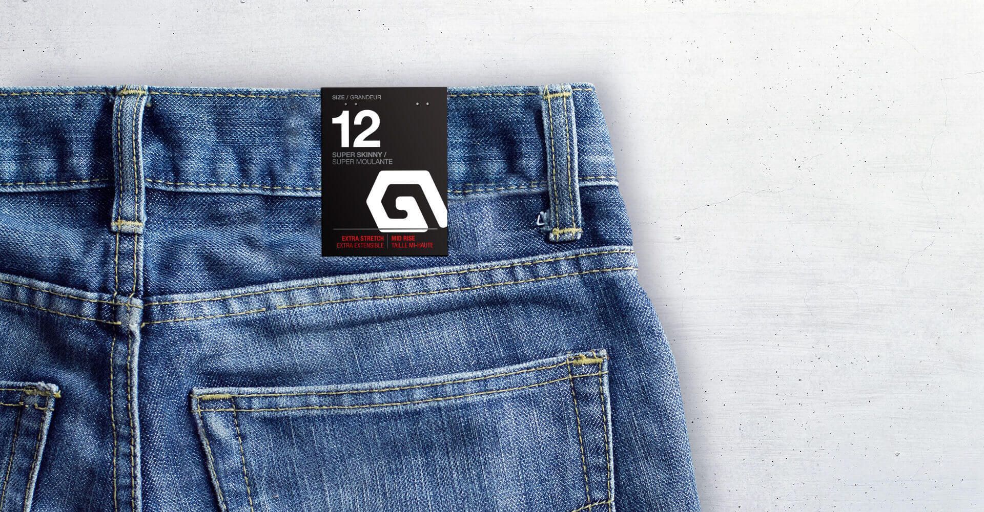 A pair of blue jeans with a tag on the back pocket.