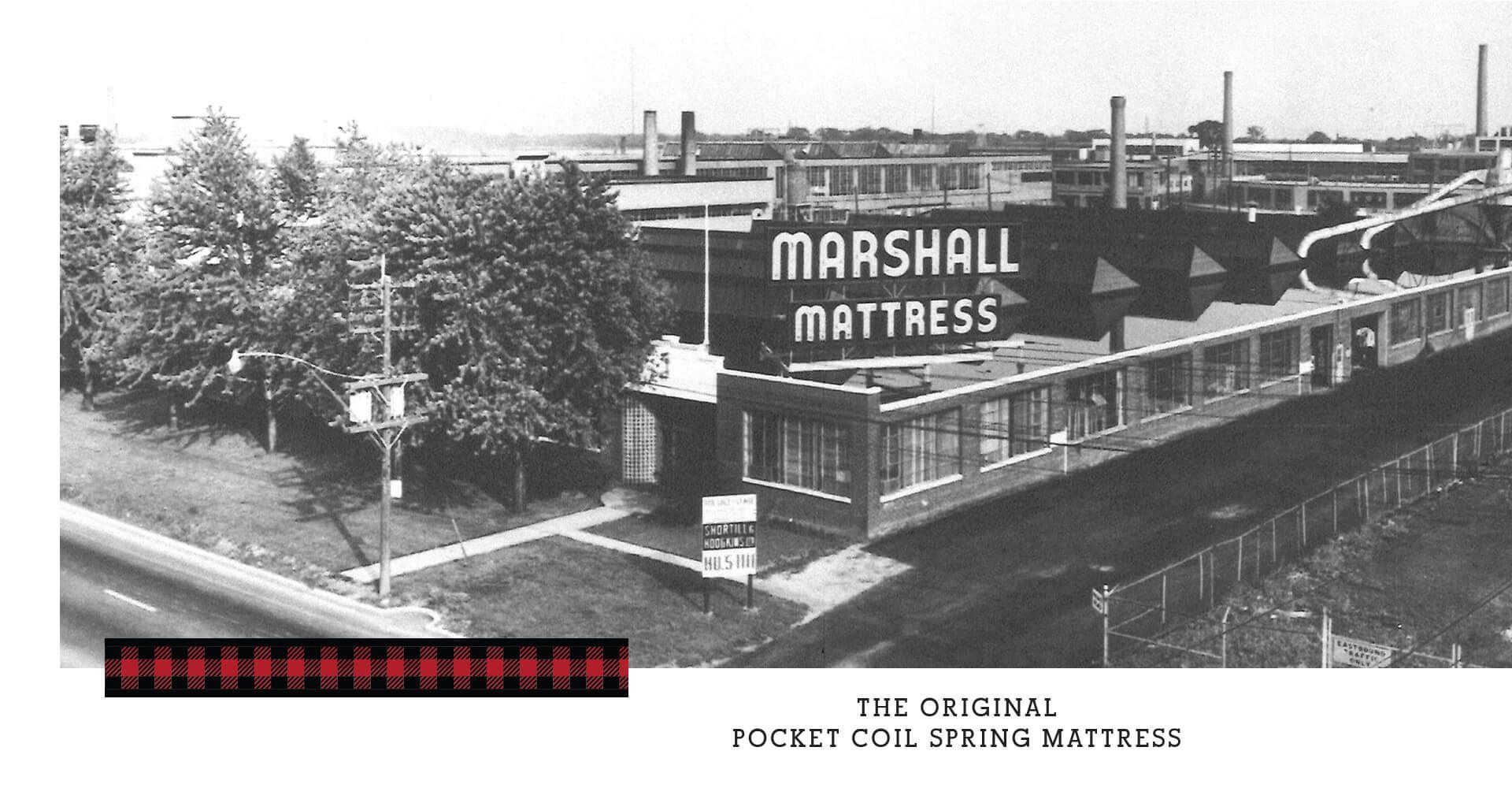 A black and white photo of a marshall mattress factory