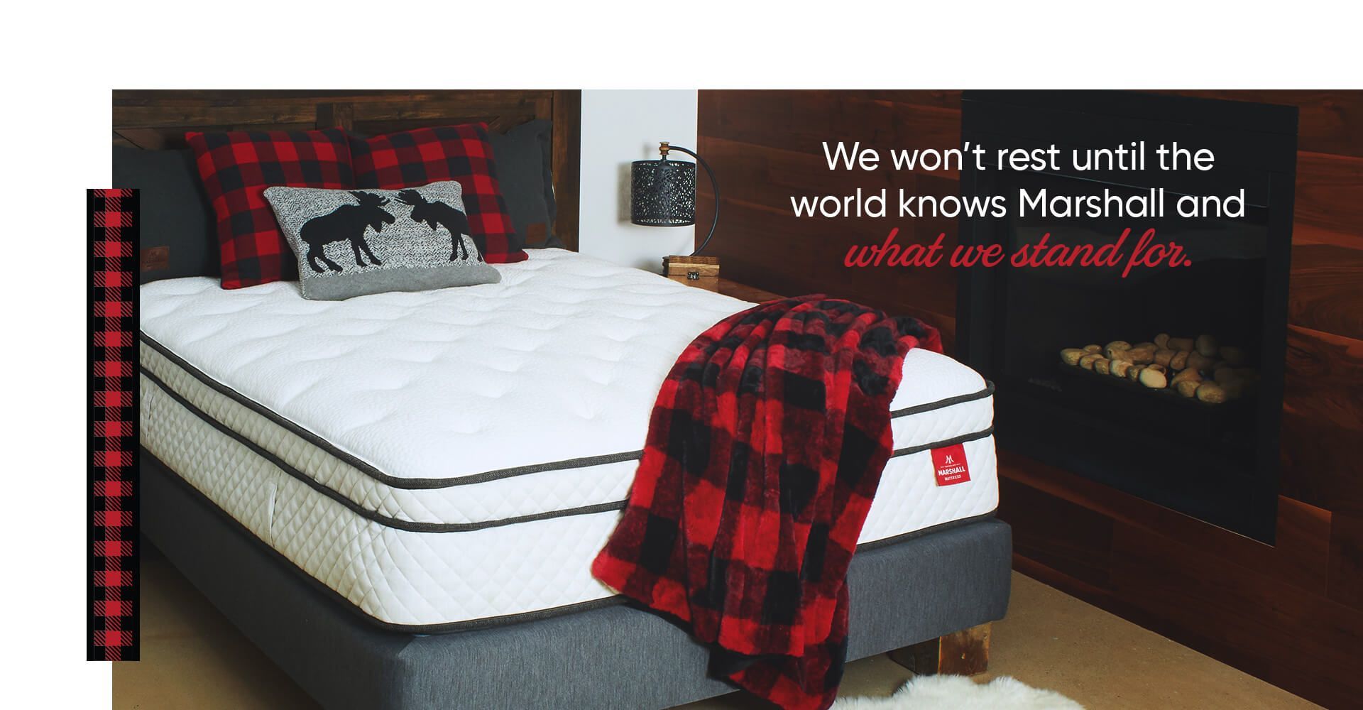 A bed with a mattress and a plaid blanket on it