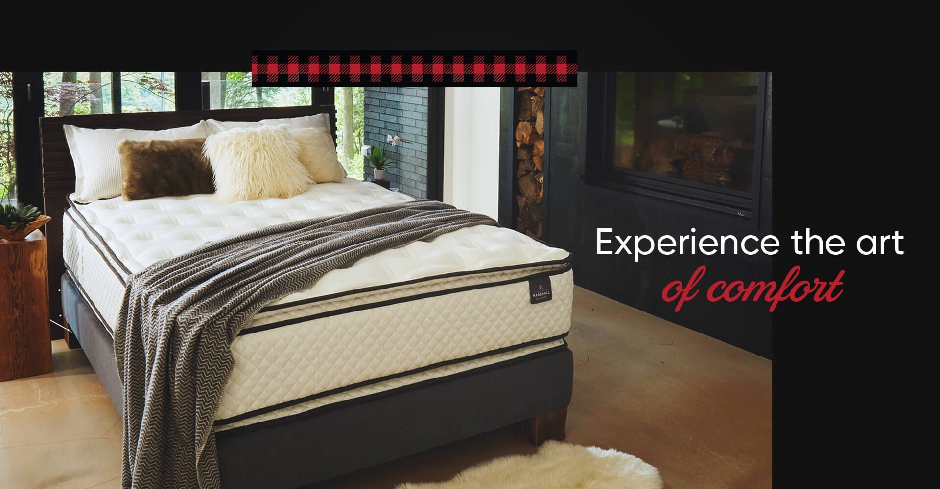 A bed with a mattress and pillows in a bedroom.