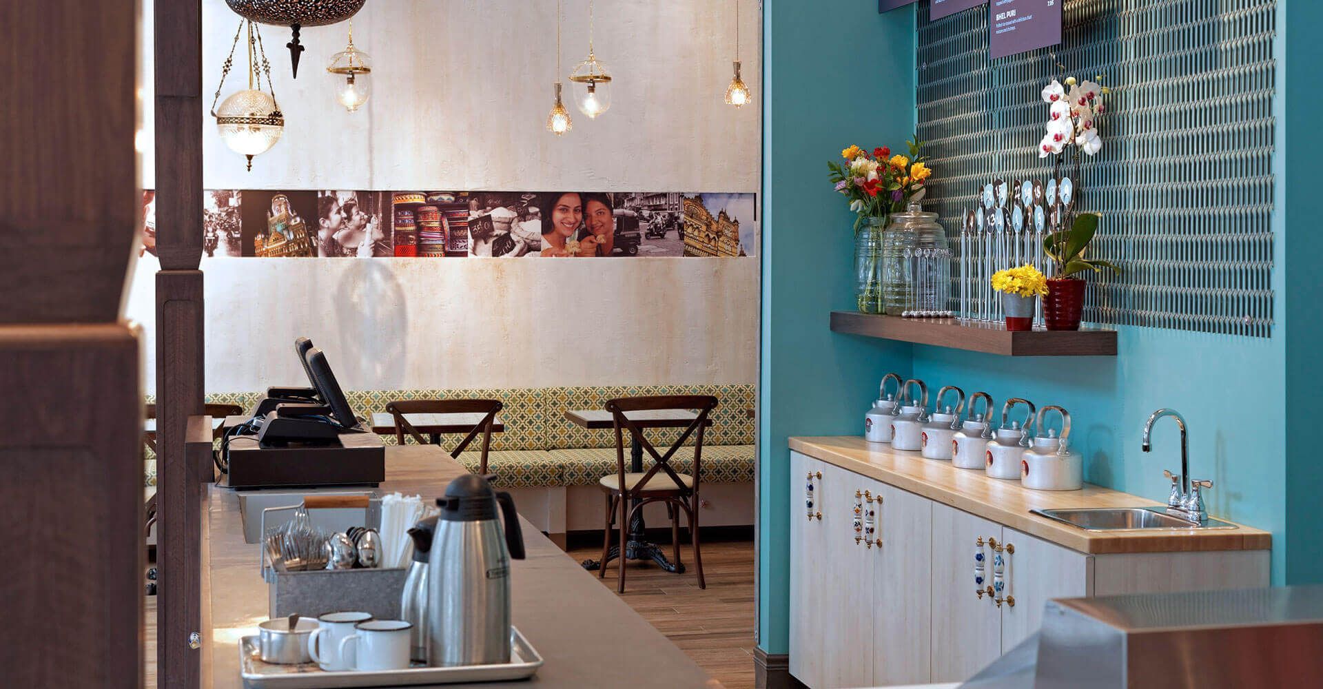 A kitchen in a restaurant with a sink and tables