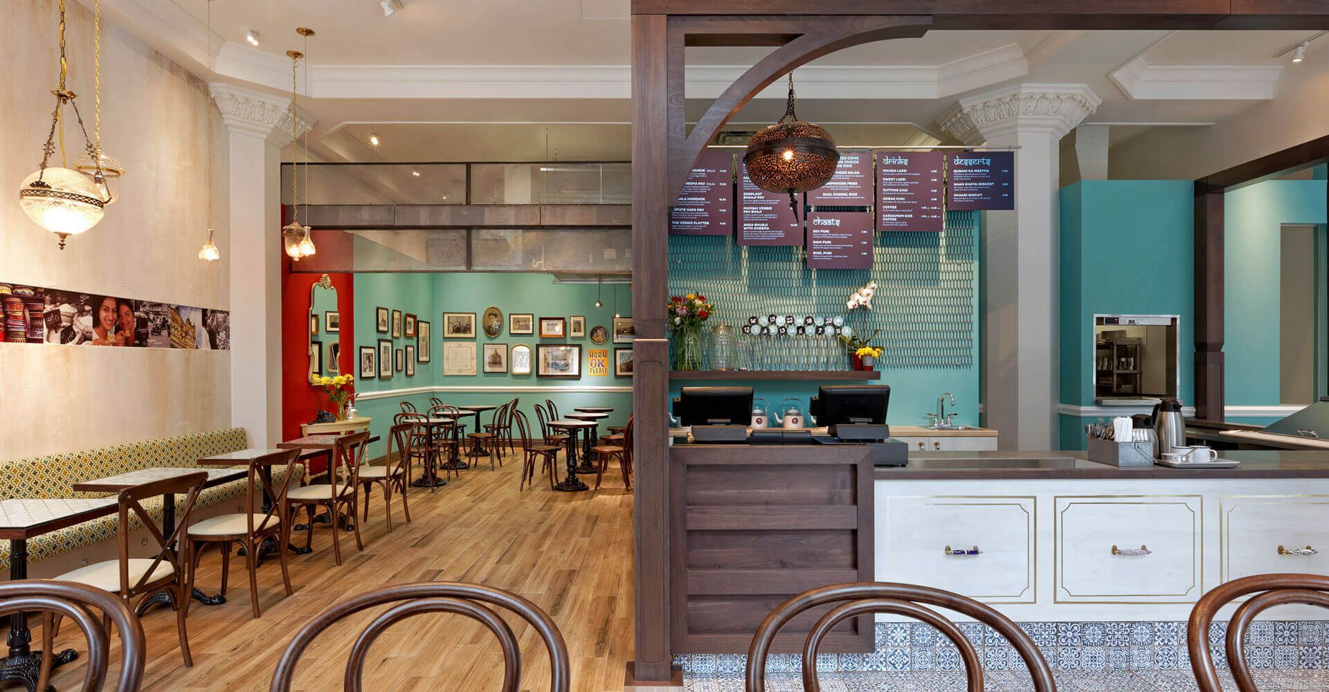 A restaurant with tables and chairs and a counter.