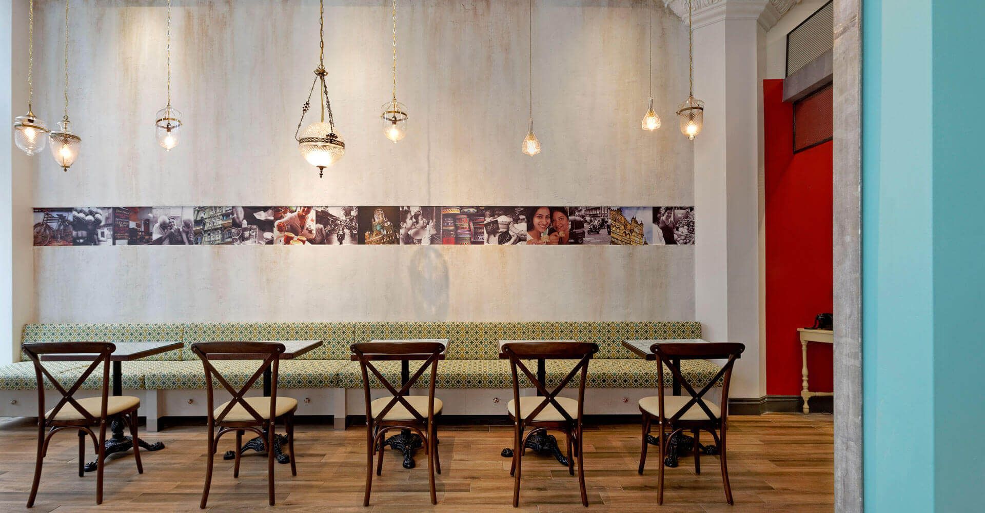 A restaurant with tables and chairs and a painting on the wall