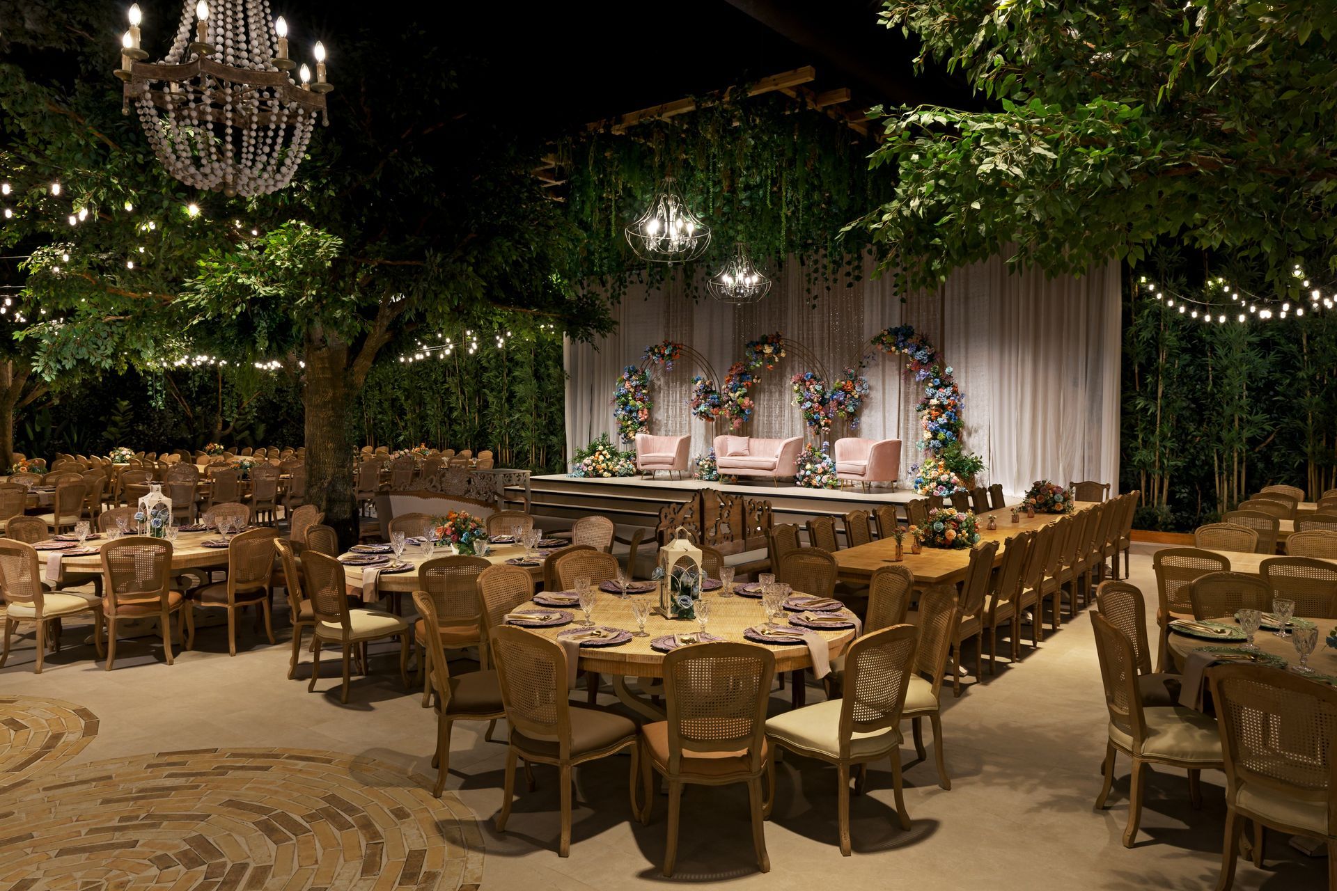 A large room filled with tables and chairs and a chandelier.