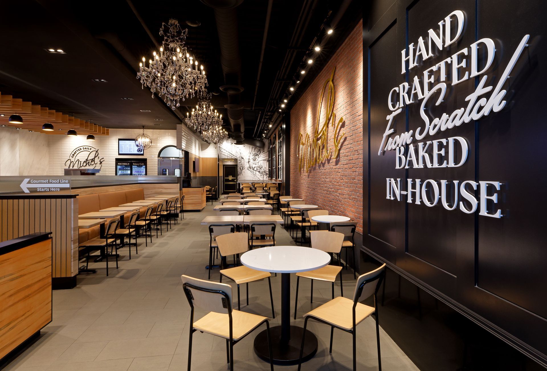 A restaurant with tables and chairs and a sign that says hand crafted from scratch baked in house
