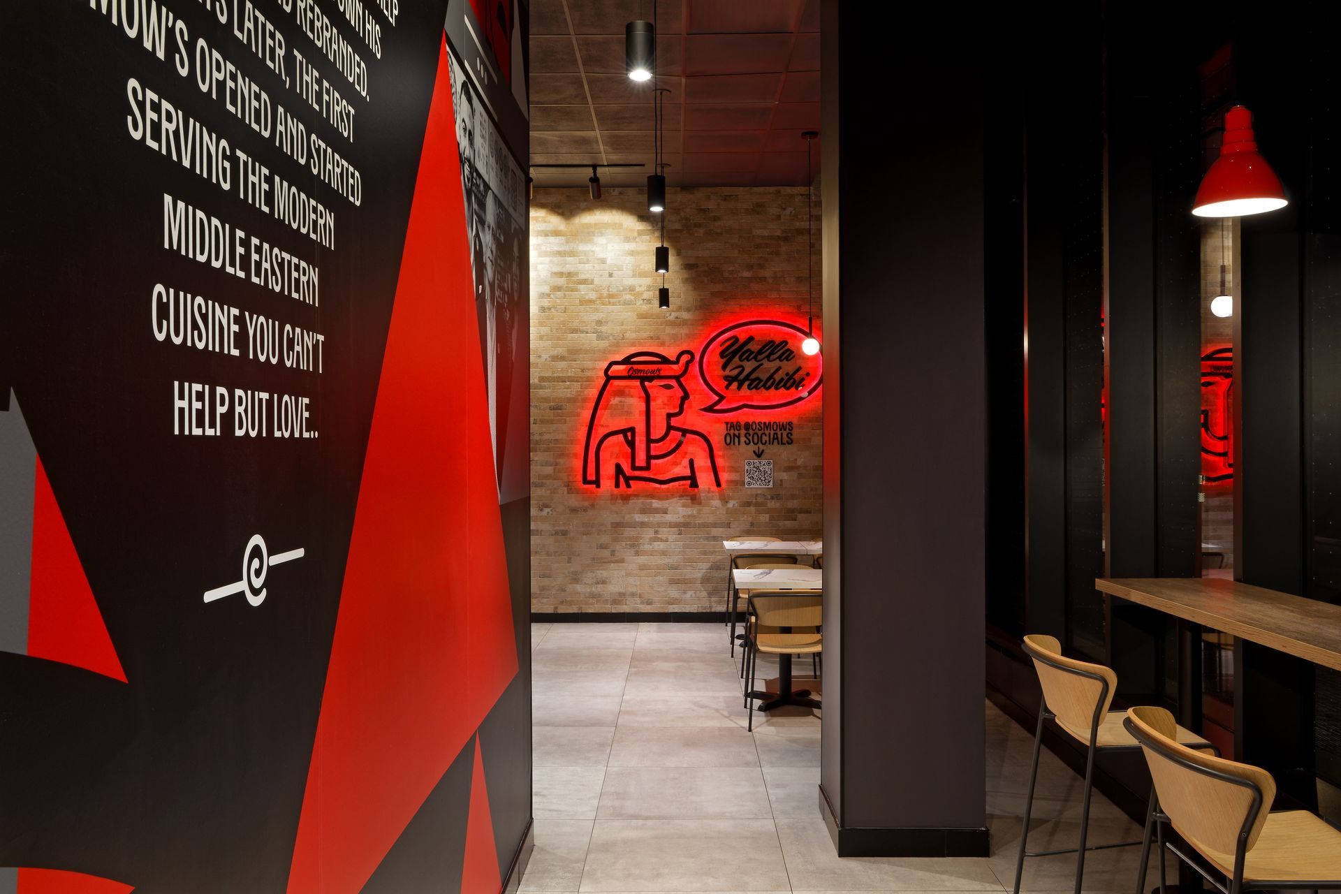 A hallway in a pizza hut restaurant with tables and chairs.