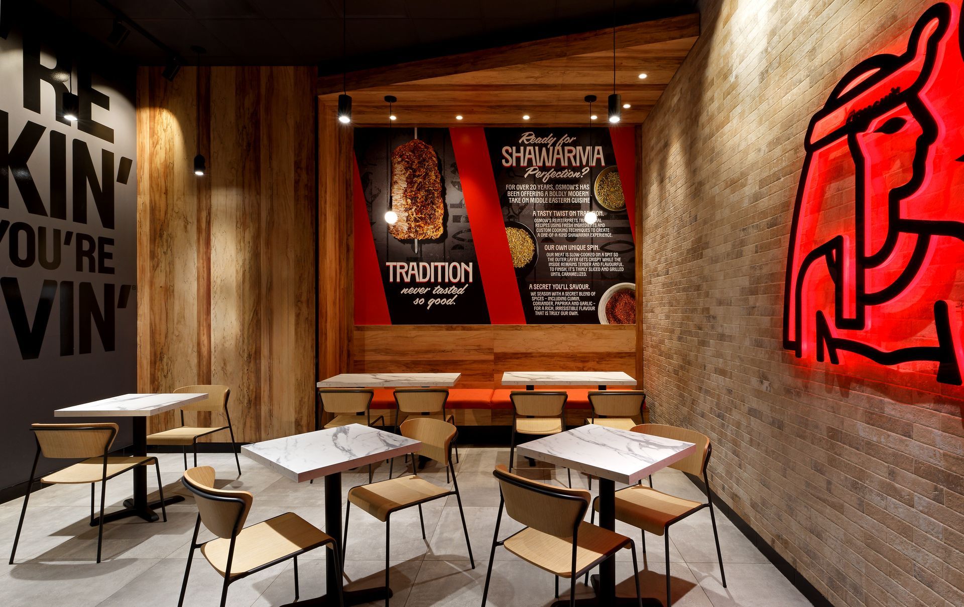 A restaurant with tables and chairs and a sign that says re kin you 're vin