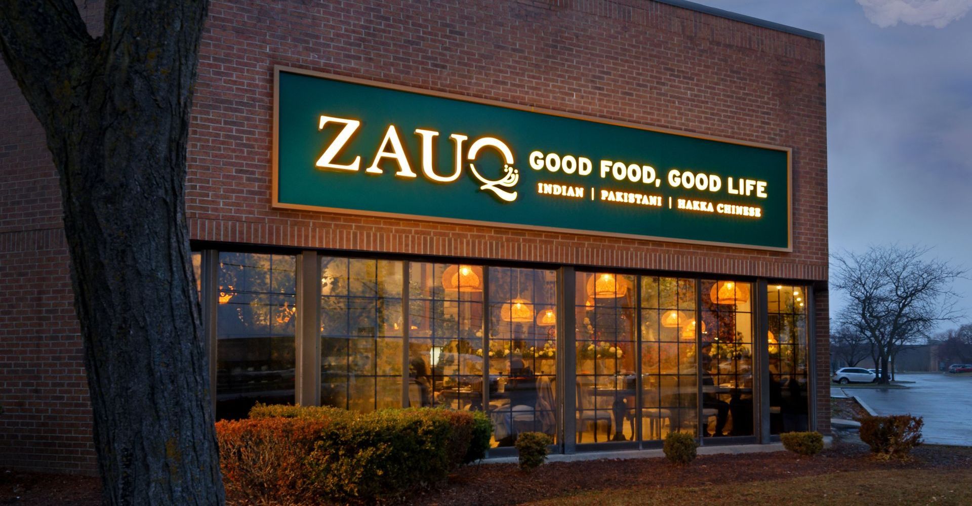 A building with a sign that says zauq good food good life