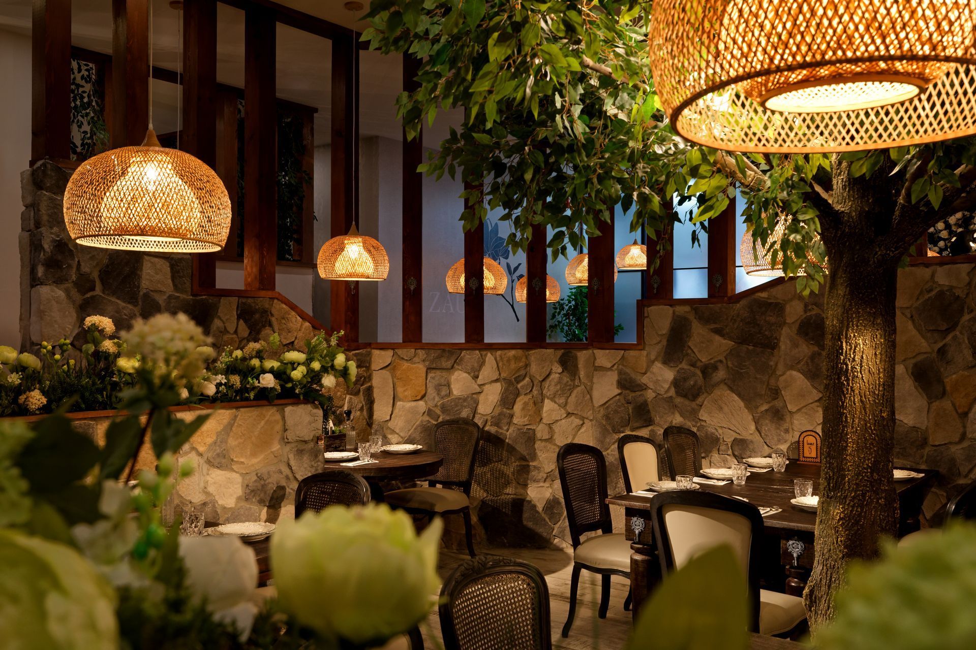 An artist 's impression of a restaurant with tables and chairs.