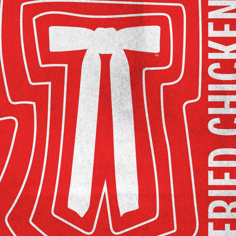 A restaurant with tables and chairs and a sign that says fresh ideas from the chicken experts