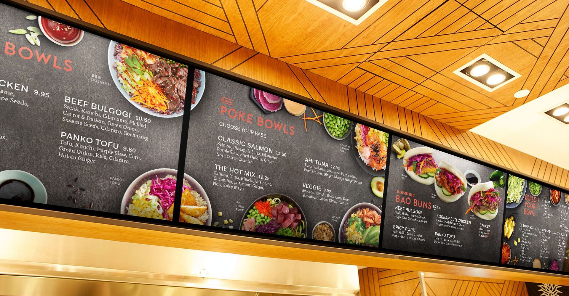 A chalkboard menu for bowls is hanging from the ceiling of a restaurant.