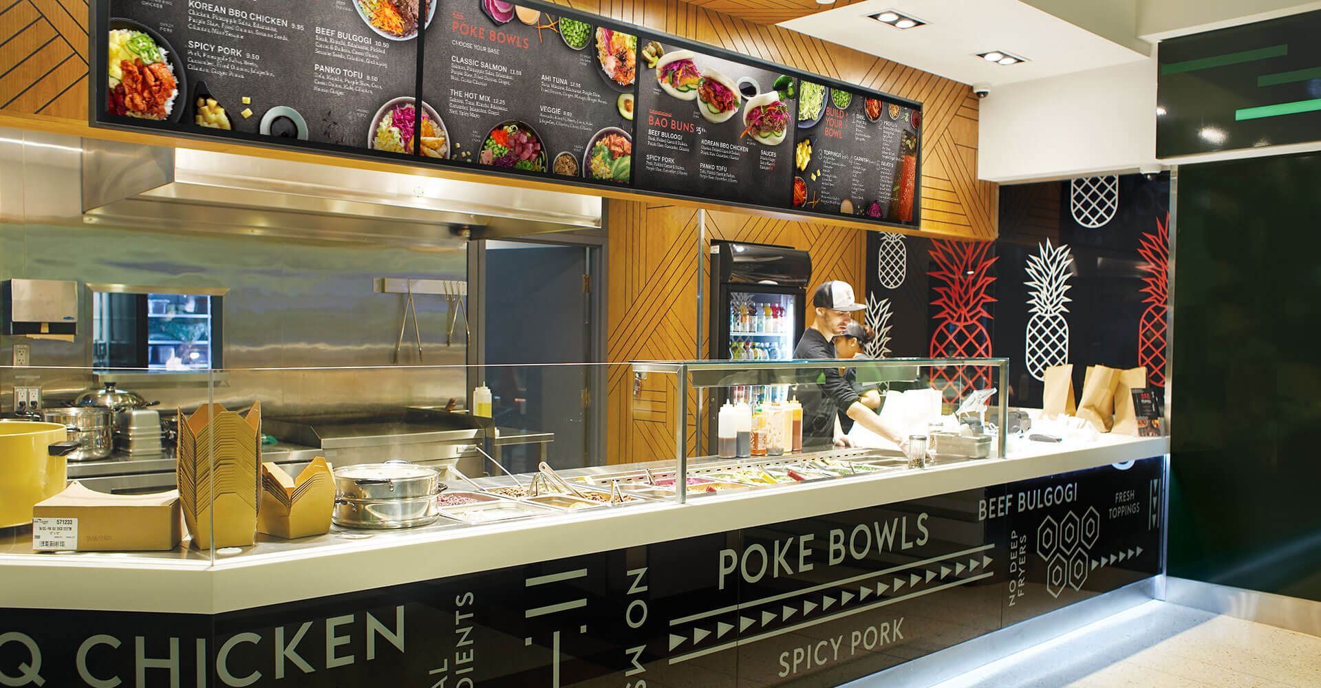 A restaurant with a sign that says poke bowls on it