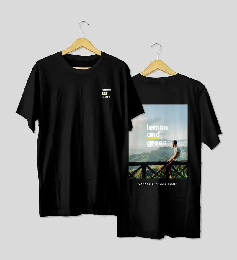 A black t-shirt is hanging on a wooden hanger.