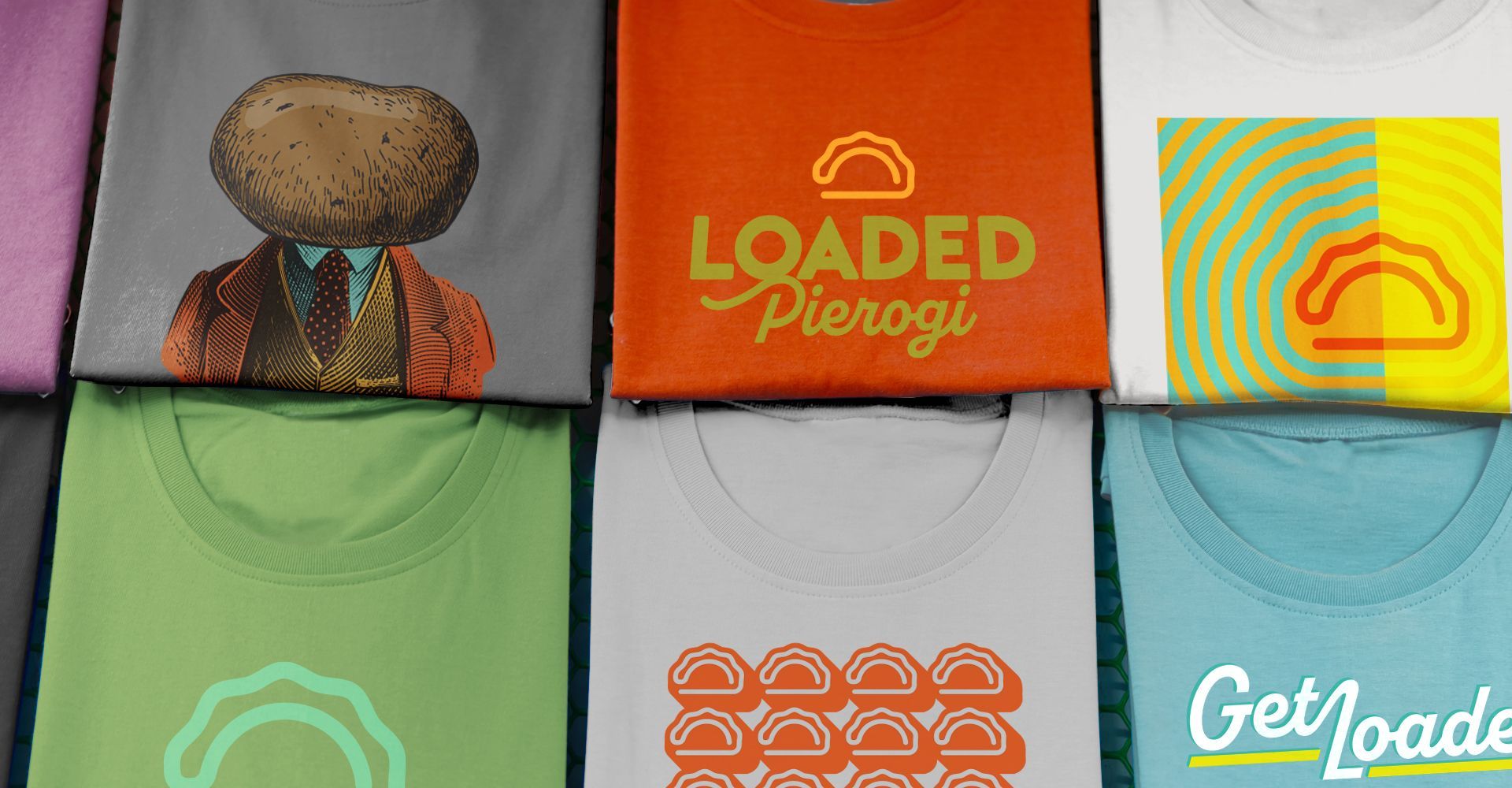 A bunch of shirts are stacked on top of each other and one of them says loaded pierogi